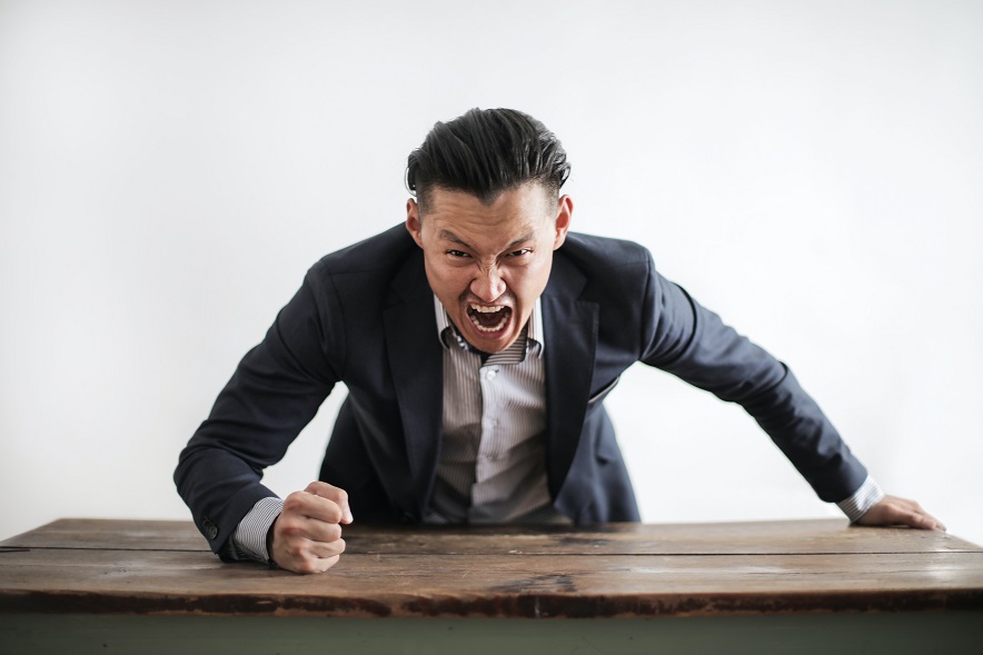 Boss slamming fist on desk